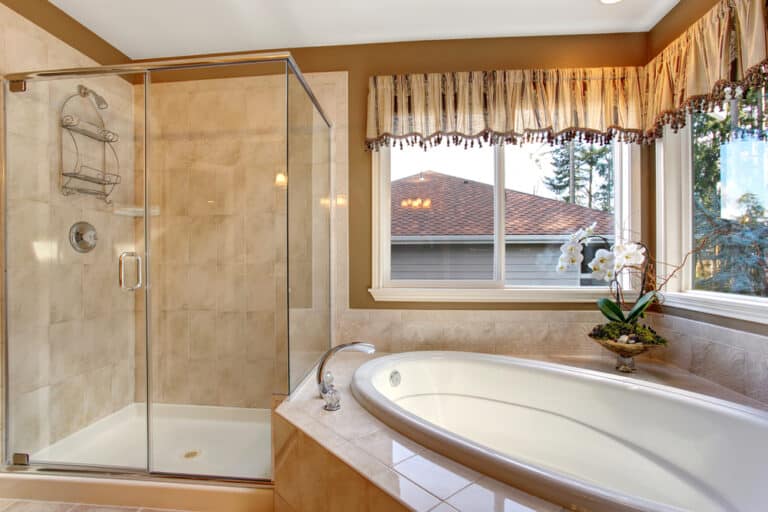 A nice bathroom with installed bathtub and a glass shower