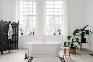 Cozy bathtub in the center of a classic white bathroom