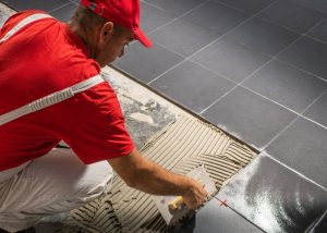 putting on new bathroom floor tiles